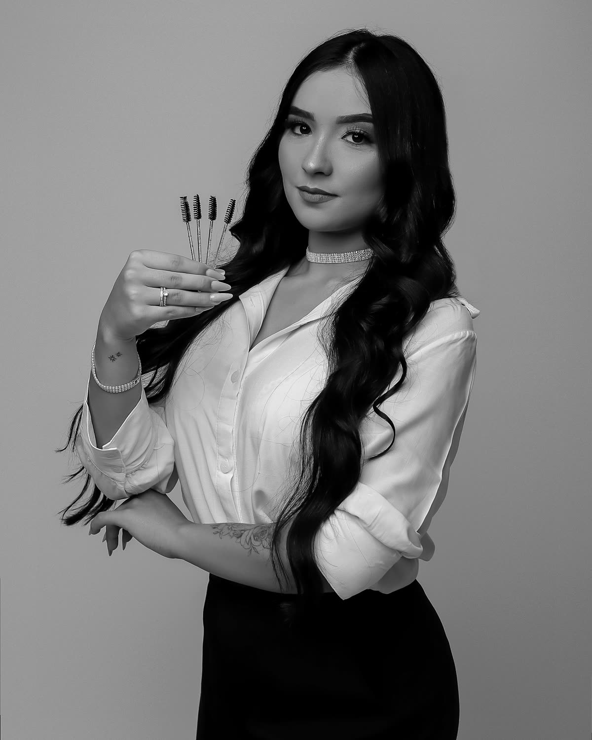Letícia Ferreira, lash designer, segurando pinças de aplicação